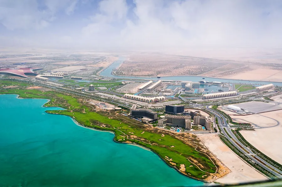 Aerial view of a coastal golf course beside a lagoon